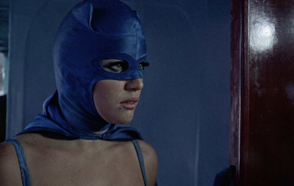 still of a woman in a retro bat mask