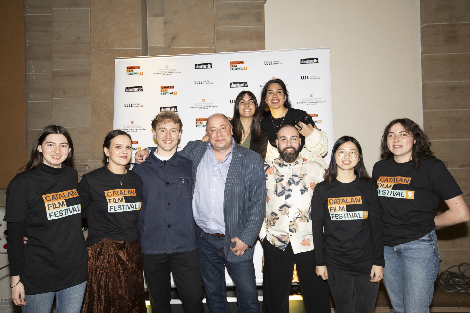 A group of CinemaAttic staff and volunteers stand together at a festival event